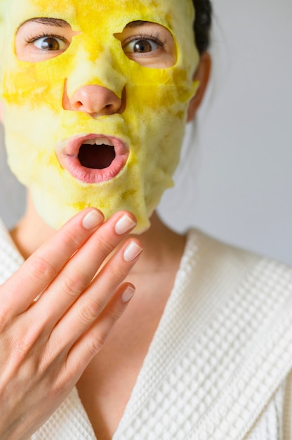 Front view of woman posing while wearing a face mask