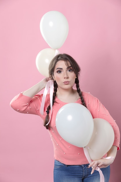 Front view of woman posing with balloons