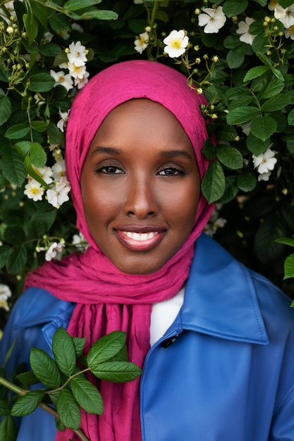 Front view woman posing with beautiful flowers