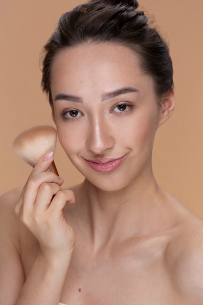 Front view woman posing with brush