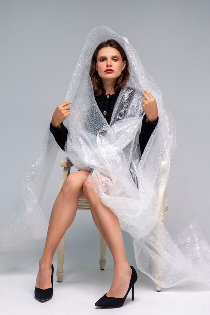 Front view woman posing with bubble wrap