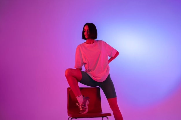 Front view woman posing with chair