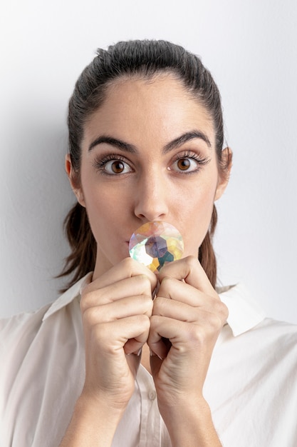 Front view of woman posing with diamond covering mouth