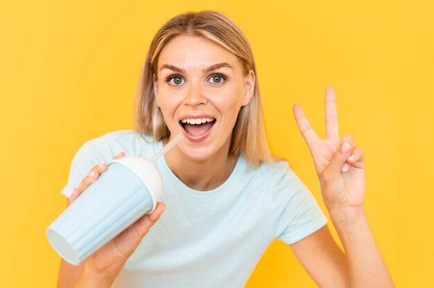 Front view woman posing with drink