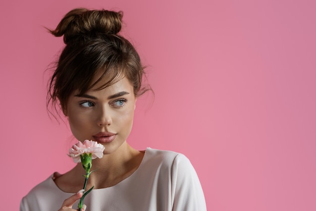 Front view woman posing with flower