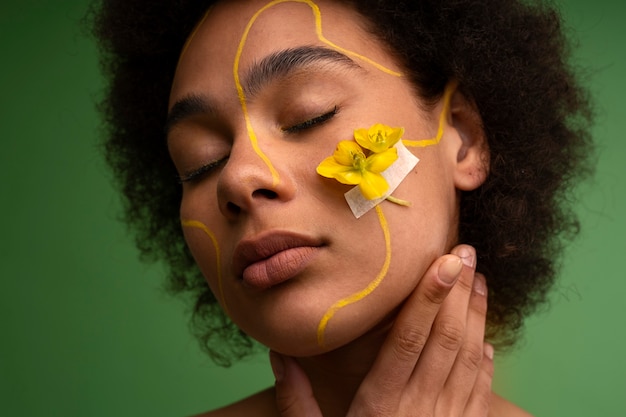 Foto gratuita donna di vista frontale che posa con il fiore