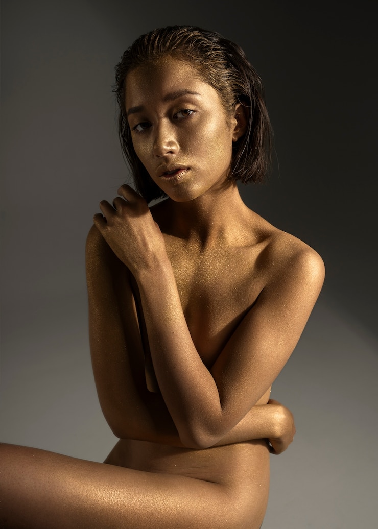Free Photo front view woman posing with gold body painting
