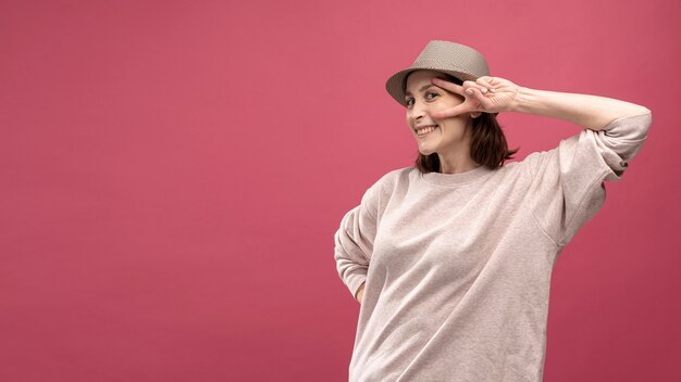 Front view of woman posing with hat and copy space