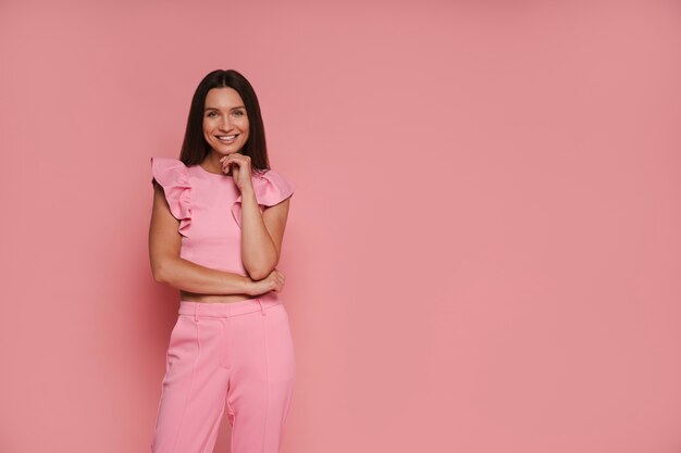Front view woman posing with pink outfit