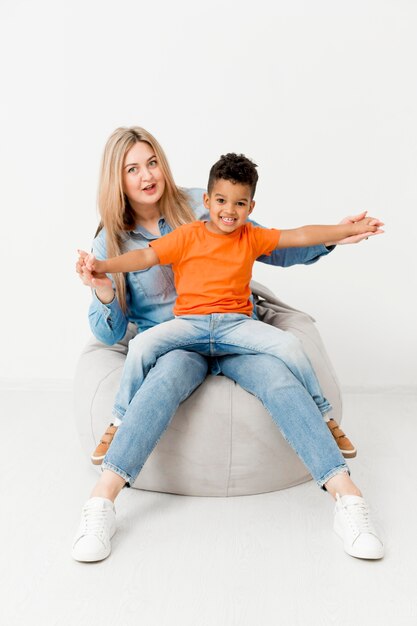 Front view of woman posing with smiley boy