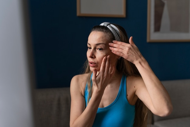 Free photo front view woman practicing facial yoga