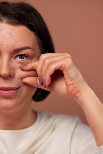 Free photo front view woman practicing facial yoga