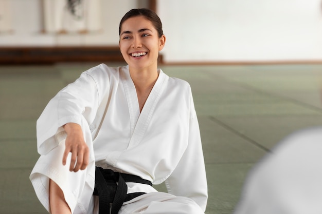 front view woman practicing taekwondo