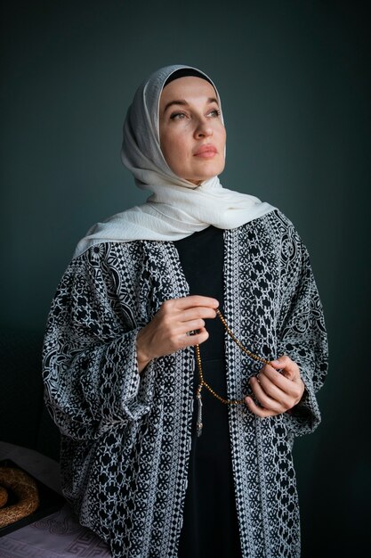 Front view woman praying indoors