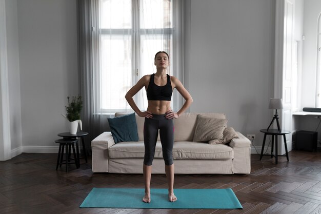 Front view of woman preparing for exercises at home