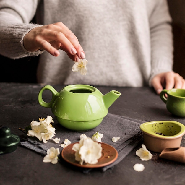 Free photo front view of woman preparing tea concept