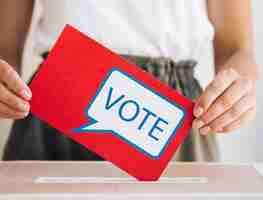 Free photo front view woman putting a voting message in a box