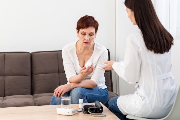 Free photo front view of woman reading her pills instructions