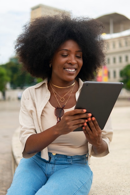 Foto gratuita lettura della donna di vista frontale sulla compressa