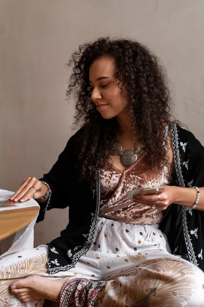 front view woman reading tarot at home