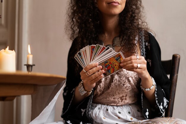 Front view woman reading tarot at home