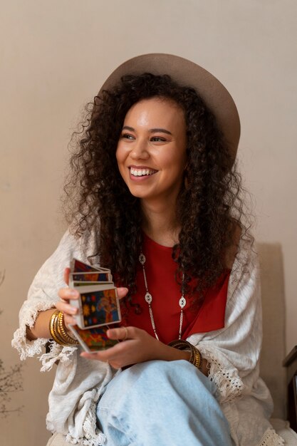 front view woman reading tarot at home