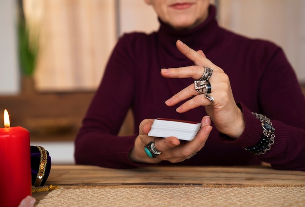 Free photo front view woman reading tarot