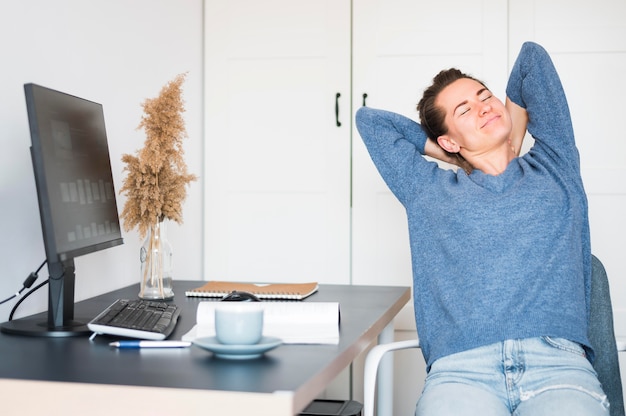 Free photo front view of woman relaxing at desk