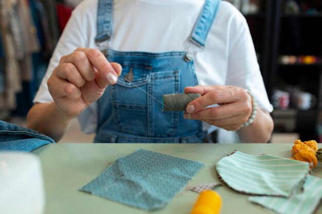 Front view woman repairing fashion goods