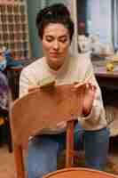 Free photo front view woman restoring wooden chair