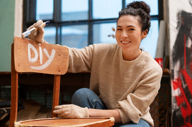 Free photo front view woman restoring wooden furniture