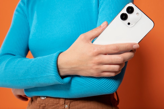 Front view of woman showing her smartphone