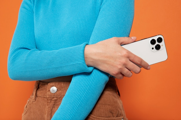 Free photo front view of woman showing her smartphone