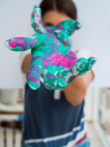 Free photo front view of woman showing painted hands