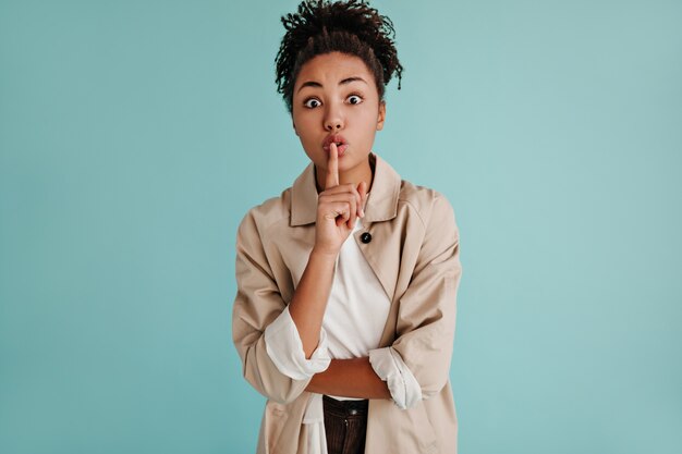 Front view of woman showing silence sign