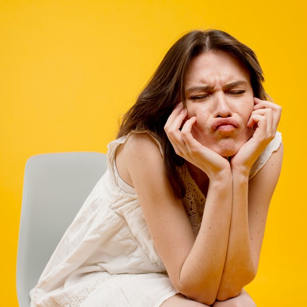 Front view of woman sitting on chair