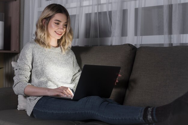 Front view of woman sitting on couch