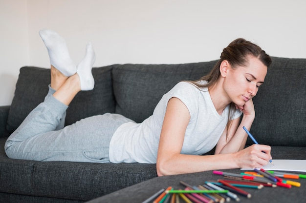 Front view of woman sitting on couch