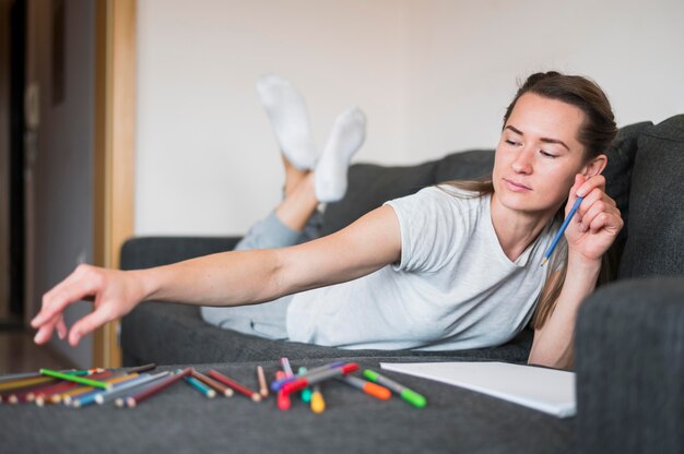 Front view of woman sitting on couch