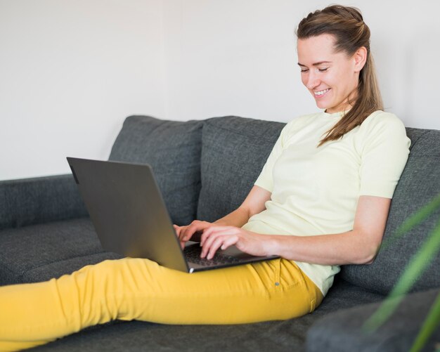 Front view of woman sitting on couch