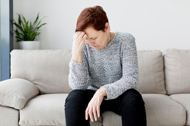 Front view of woman sitting on couch