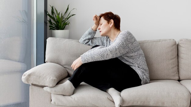 Front view of woman sitting on couch