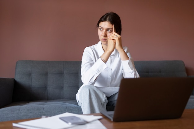 Front view woman sitting on couch