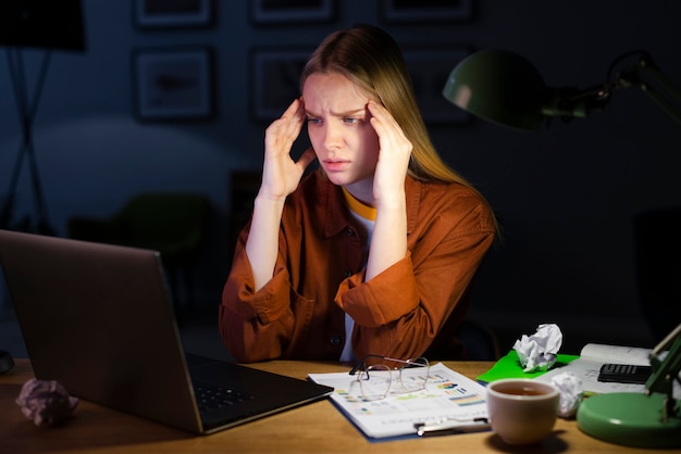 Free photo front view of woman sitting at desk