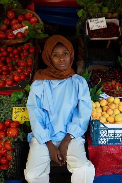 Front view woman sitting near fruits