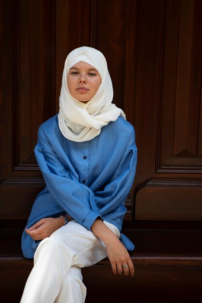 Front view woman sitting on stairs