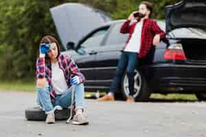 Free photo front view of woman sitting on tire