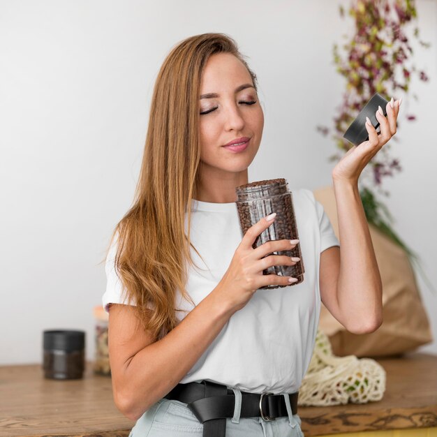 Front view woman smelling coffee beans