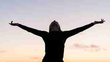 Free photo front view woman standing with her arms up