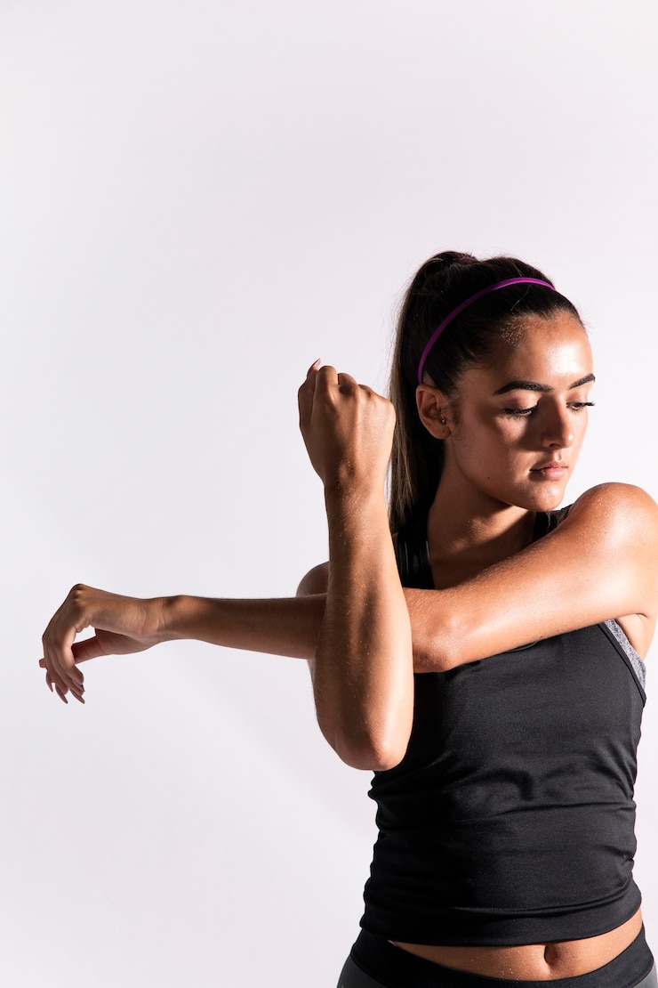 Free Photo front view woman stretching her arm